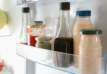 Different sauces on shelf in fridge