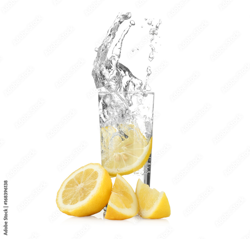 Canvas Prints fresh slice of lemon falling in glass with water on white background