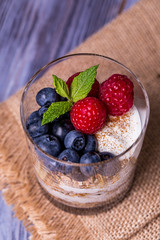 yogurt with muesli and berries on a wooden table