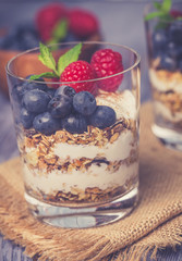 yogurt with muesli and berries on a wooden table