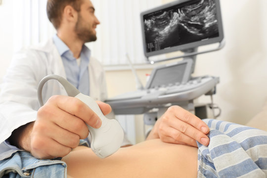 Doctor conducting ultrasound examination of woman in clinic