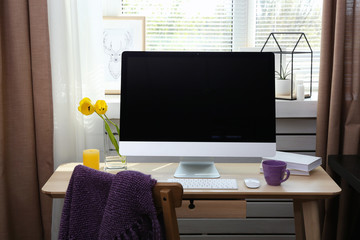 Modern comfortable workplace with computer near window sill at home