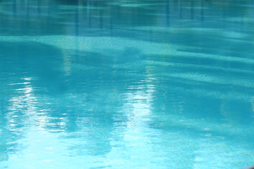 Fototapeta na wymiar Clear blue water in swimming pool at resort