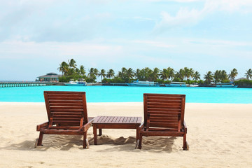 Sun loungers on beach at sea resort