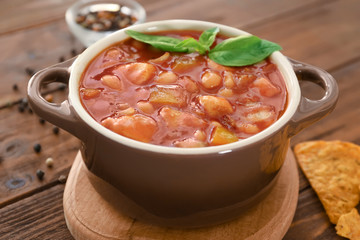 Casserole with delicious turkey chili on wooden table