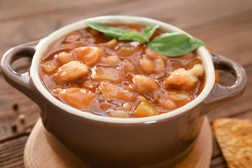 Casserole with delicious turkey chili on wooden table