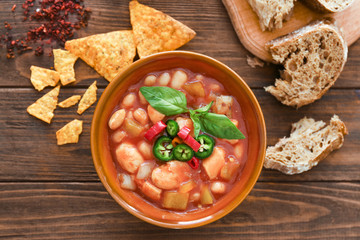 Composition with delicious turkey chili in bowl on wooden table