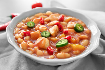 Bowl with delicious turkey chili on kitchen table