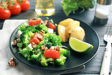 Plate with broccoli salad on table