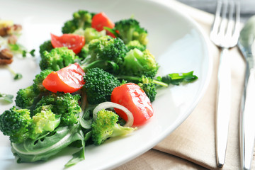 Plate with broccoli salad on table