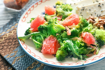 Plate with broccoli salad on table