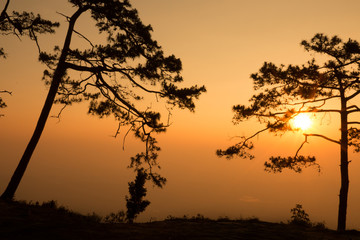 silhouette of serenely the cliff at the valley and mountains with sunrise in the morning