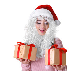 Attractive lady in Christmas hat  and fake Santa Claus beard holding gift boxes on white background