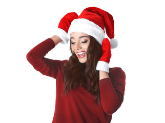 Beautiful emotional woman in Christmas hat and red winter gloves on white background