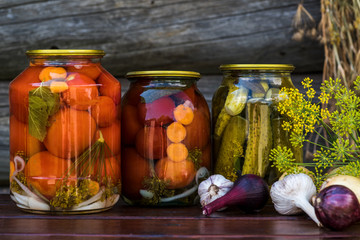 Canned tomatoes and cucumbers with fresh vegetables