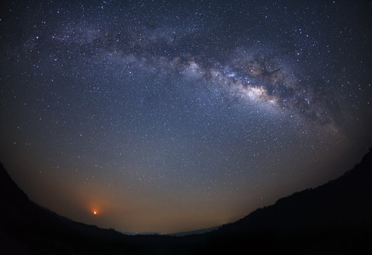 Milky way galaxy and moon light with stars over moutain at Phu Hin Rong Kla National Park,Phitsanulok Thailand
