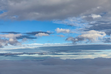 aerial of blue sky with dark raining clouds