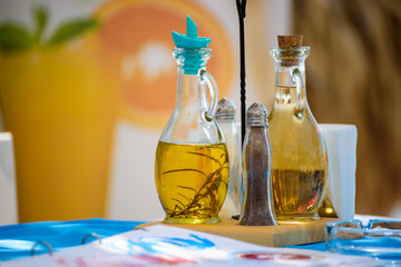 Set of olive oil and vinegar in a Greek restaurant on a seashore