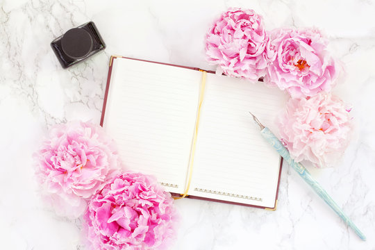Note book with peonies and ink pen. Copy space for the text