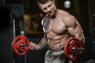 Fototapeta na wymiar Strong and handsome athletic young tattoo man with muscles