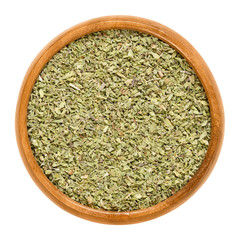 Oregano dried in wooden bowl. Origanum vulgare, sometimes wild marjoram. Herb with aromatic olive...