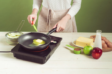 House wife wearing apron making. Steps of making cooking apple cake. Cutting green apple.