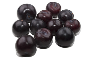 many sweet and organic plum on white background