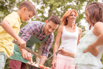 Family on vacation having barbecue