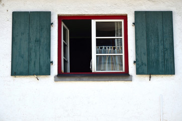 Windows with shutters on a house close up