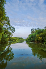 Lake in wild evening forest, no sun in frame