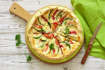 Vegetable rustic pie ( quiche) with tomatoes, zucchini and soft cheese