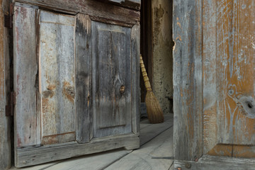 broom inside doors of a wooden cabin in the Tusheti village of Shenako
