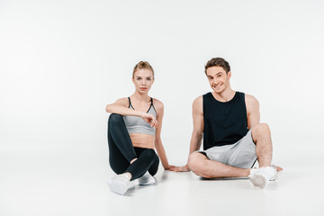 Obraz premium fit couple sitting on floor