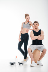 Fototapeta na wymiar couple posing with fitness equipment