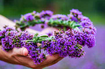 purple flower wreath on hands