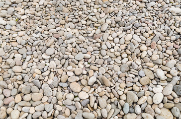 part of a rocky beach strewn with small smooth pebble gray
