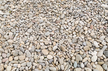 part of a rocky beach strewn with small smooth pebble gray