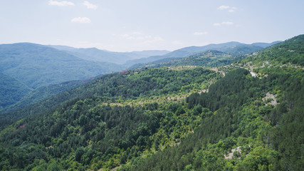 Fototapeta na wymiar High In The Mountains In Sunny Day Aerial Shot