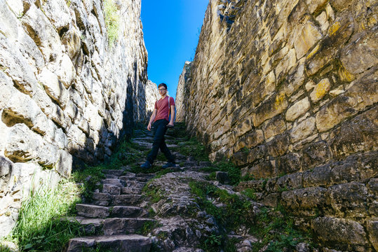 young tourist walks trough the preinca ruins of Kuelap near Chachapoyas / Peru/ south america