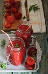 Strawberry smoothie, fresh fruits, leaf of mint.