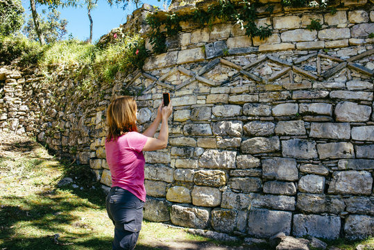 A female tourist take selfies in front of pre-inca walls /Kuelap / Chachapoyas/ Peru/ south america