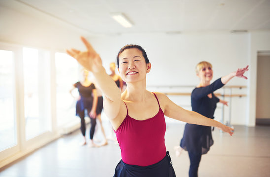 Smiling Dance Teacher Leading Seniors In A Ballet Class