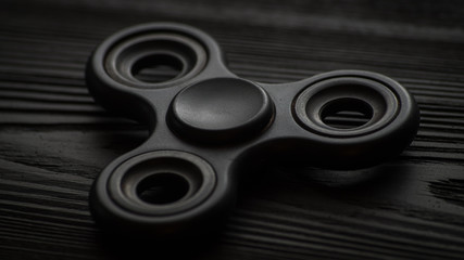 top wiew black spinner on a black background