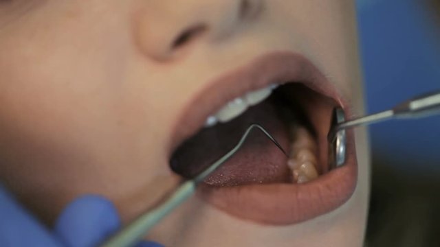 Doctor doing dental treatment to his patient in clinic