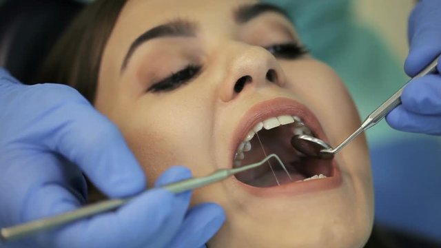 Doctor doing dental treatment to his patient in clinic