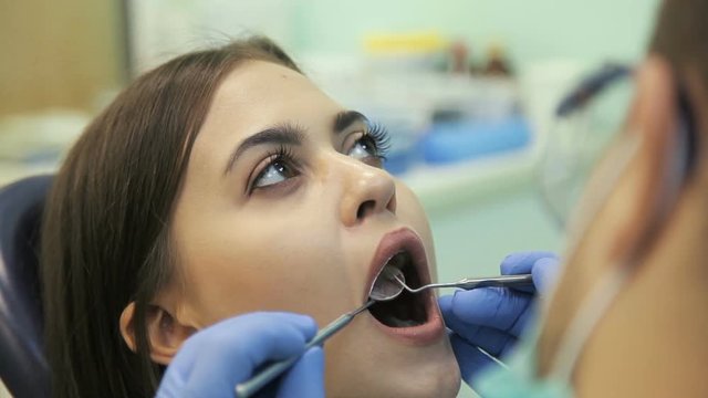Doctor doing dental treatment to his patient in clinic
