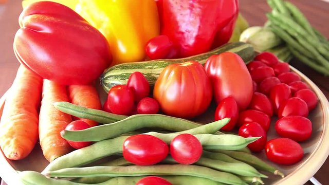 Close-up of fresh summer vegetables on turning plate