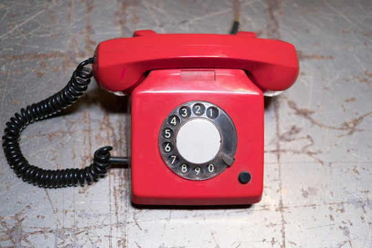 old red phone on table - vintage telephone on desk
