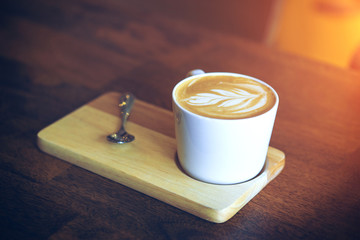 Hot latte coffee on wooden table.