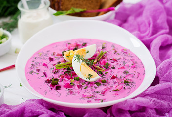 Cold beetroot (beet) soup on yogurt with egg, onion and cucumbers.